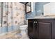 This bathroom has a shower-tub combo, neutral flooring and a granite-topped vanity at 2109 Trillium Blvd, Brooksville, FL 34604