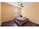 Bright bedroom with ceiling fan, window blinds, wood floors and a bed at 2109 Trillium Blvd, Brooksville, FL 34604