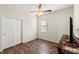 This cozy bedroom has wood floors, a ceiling fan, and a built-in closet for storage at 2109 Trillium Blvd, Brooksville, FL 34604
