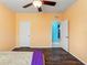 This bedroom is freshly painted with wood floors and an adjoining doorway to a bathroom at 2109 Trillium Blvd, Brooksville, FL 34604