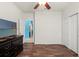 This bedroom features beautiful wood floors, a closet, and an open doorway to the bathroom at 2109 Trillium Blvd, Brooksville, FL 34604