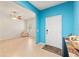 Bright foyer with blue accent wall that flows to an open floor plan, ceiling fan, and neutral tile flooring at 2109 Trillium Blvd, Brooksville, FL 34604