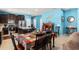 Open kitchen with stainless steel appliances, dark cabinets, a center island with seating, and a nearby dining table at 2109 Trillium Blvd, Brooksville, FL 34604