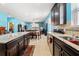 Open-concept kitchen offering granite countertops, dark cabinets and tile floors, connects to the living spaces at 2109 Trillium Blvd, Brooksville, FL 34604