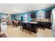 Open-concept kitchen boasts dark cabinetry, an island with seating, granite countertops, and stainless-steel appliances at 2109 Trillium Blvd, Brooksville, FL 34604