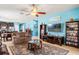 A cozy living room features tile floors, a ceiling fan, comfortable couches, an area rug, and an open concept design at 2109 Trillium Blvd, Brooksville, FL 34604