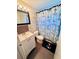 Nautical themed bathroom with vanity and tiled shower at 3523 Cambridge St, New Port Richey, FL 34652