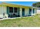 Quaint single-story home with a charming front porch and well-maintained landscaping at 3523 Cambridge St, New Port Richey, FL 34652