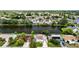 Aerial view of homes situated on the waterfront showcasing serene lake views and lush greenery in the neighborhood at 3526 Overland Dr, Holiday, FL 34691