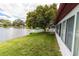 Waterfront backyard with well-maintained lawn and a beautiful view of the lake at 3526 Overland Dr, Holiday, FL 34691