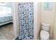 Bathroom featuring toilet and blue, seashell-themed shower curtain at 3526 Overland Dr, Holiday, FL 34691