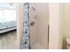 Bright bathroom featuring a tiled shower, modern fixtures, and beach-themed decor at 3526 Overland Dr, Holiday, FL 34691
