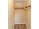 A practical closet with a wooden rod and shelf offers efficient storage in a compact space at 3526 Overland Dr, Holiday, FL 34691