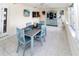 Bright sunroom dining area with tile flooring and an antique cabinet for display at 3526 Overland Dr, Holiday, FL 34691