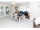 Cozy dining area featuring a built-in bench, set table, and doors leading to the sunroom at 3526 Overland Dr, Holiday, FL 34691