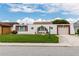 Unique architectural design and lush green lawn showcasing the home's curb appeal and character at 3526 Overland Dr, Holiday, FL 34691