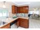 Traditional kitchen with wood cabinets, tile floors, and marble countertop at 3526 Overland Dr, Holiday, FL 34691