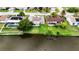 Back view of house with waterfront view, featuring lush green lawn at 3526 Overland Dr, Holiday, FL 34691