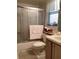 Bathroom featuring shower with glass door and a matching set of seashell embroidered towels at 4529 Whitton Way # 214, New Port Richey, FL 34653
