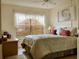 Cozy bedroom featuring neutral colors, a ceiling fan, and lots of natural light from the window at 4529 Whitton Way # 214, New Port Richey, FL 34653