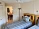 Guest bedroom with two beds and a view through the door to the dining area at 4529 Whitton Way # 214, New Port Richey, FL 34653