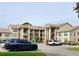 Exterior view of the multi-story residential building with parking and landscaping at 4529 Whitton Way # 214, New Port Richey, FL 34653