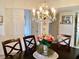 Dining room featuring decorative chandelier and view into entry hallway at 4529 Whitton Way # 214, New Port Richey, FL 34653