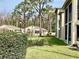 View of building exteriors surrounded by landscaping and lush green lawns at 4529 Whitton Way # 214, New Port Richey, FL 34653