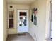 Cozy front porch with a welcome mat, an American flag, and a charming window view into the home's interior at 4529 Whitton Way # 214, New Port Richey, FL 34653