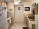 Functional kitchen design featuring ample cabinet space, tiled backsplash, and tile flooring at 4529 Whitton Way # 214, New Port Richey, FL 34653