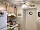 Cozy kitchen with white appliances including range, microwave and refrigerator at 4529 Whitton Way # 214, New Port Richey, FL 34653