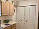 Kitchen with pantry and upper cabinets provides ample storage options at 4529 Whitton Way # 214, New Port Richey, FL 34653