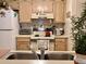 Cozy kitchen with white appliances including range, microwave and refrigerator at 4529 Whitton Way # 214, New Port Richey, FL 34653