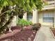 Professionally landscaped building entrance with vibrant plantings, mulch, and manicured lawn, enhancing curb appeal at 4529 Whitton Way # 214, New Port Richey, FL 34653