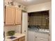 A bright laundry room includes cabinetry, a closet, and a washer and dryer at 4529 Whitton Way # 214, New Port Richey, FL 34653