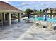 Relaxing pool area boasts ample seating, umbrellas, and a covered patio, perfect for community enjoyment and leisure at 4529 Whitton Way # 214, New Port Richey, FL 34653