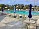 Enjoy the community pool with tables, chairs, umbrellas, and lounging areas available for residents at 4529 Whitton Way # 214, New Port Richey, FL 34653