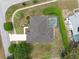 Top down aerial view of a single-story home with a screened in pool, manicured hedges, and driveway at 6112 Kinlock Ave, Spring Hill, FL 34608