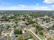 Aerial shot displays a residential community with mature trees, varied homes, and well-kept lawns under a bright sky at 6112 Kinlock Ave, Spring Hill, FL 34608