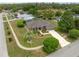 Aerial view of a well-maintained single-story home with lush landscaping and a long driveway in a quiet neighborhood at 6112 Kinlock Ave, Spring Hill, FL 34608