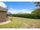 This is a large, grassy backyard with a pool and a tall hedge for extra privacy at 6112 Kinlock Ave, Spring Hill, FL 34608