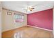 Bedroom with hardwood floors, a ceiling fan, and a window at 6112 Kinlock Ave, Spring Hill, FL 34608