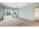 Spacious carpeted bedroom featuring large windows with pool views and a ceiling fan at 6112 Kinlock Ave, Spring Hill, FL 34608