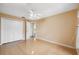 This bedroom offers ample natural light, hardwood floors, and a ceiling fan at 6112 Kinlock Ave, Spring Hill, FL 34608