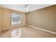 Bedroom featuring hardwood floors, a ceiling fan, and a window with blinds at 6112 Kinlock Ave, Spring Hill, FL 34608