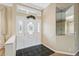 Welcoming entryway featuring tiled floors, decorative front door, and transom window at 6112 Kinlock Ave, Spring Hill, FL 34608