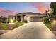 Charming single-story home features a well-manicured lawn, screened garage, and long driveway at 6112 Kinlock Ave, Spring Hill, FL 34608