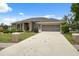 Charming single-story home features a well-manicured lawn, screened garage, and long driveway at 6112 Kinlock Ave, Spring Hill, FL 34608