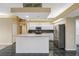Spacious kitchen with white cabinets, stainless steel appliances, and a large island with countertop seating at 6112 Kinlock Ave, Spring Hill, FL 34608