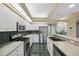Well-lit kitchen featuring stainless steel appliances, granite countertops, and dark-tiled backsplash and flooring at 6112 Kinlock Ave, Spring Hill, FL 34608